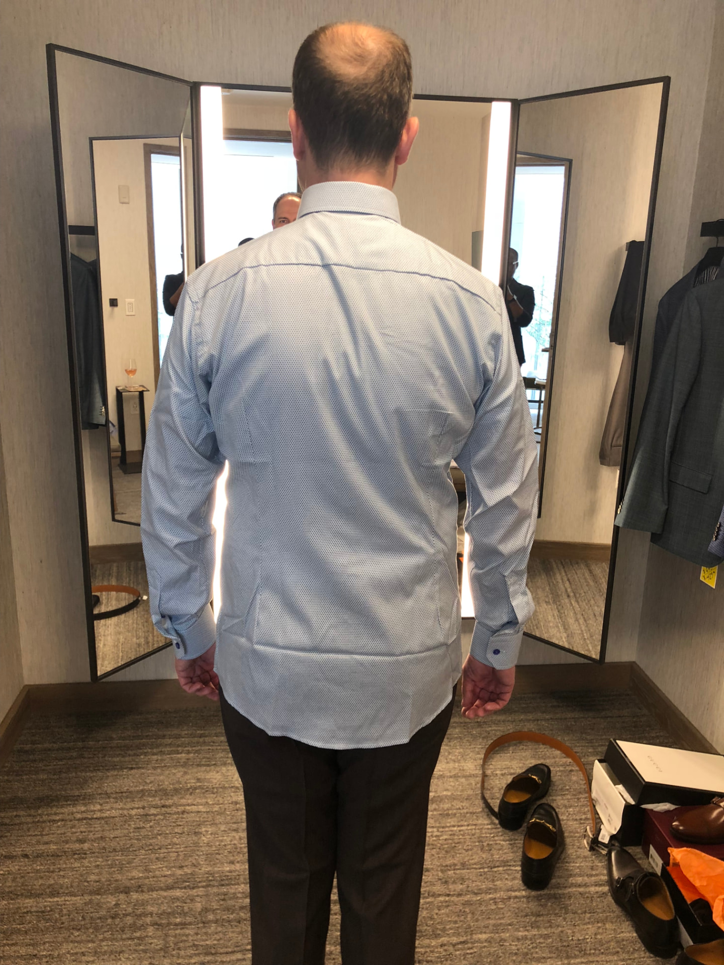 A second look in the fitting room mirror during a fitting