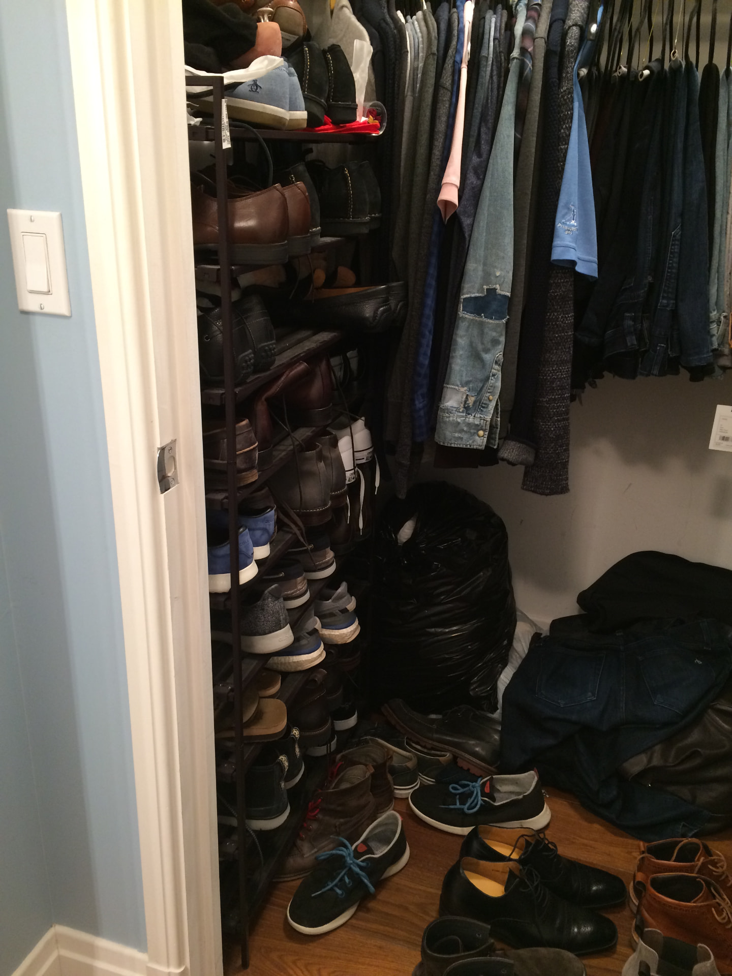 A closet mid-edit, with clothes and shoes being sorted