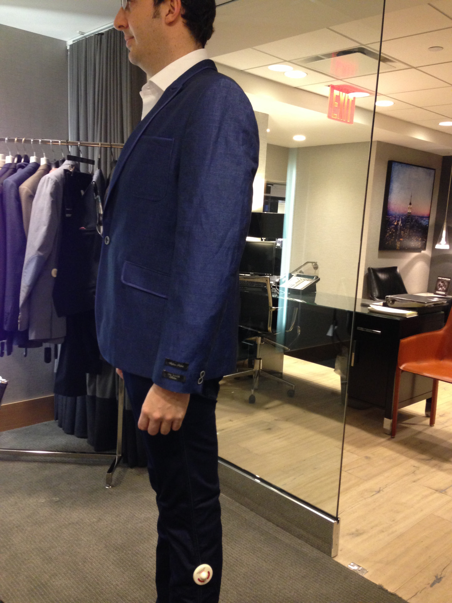 David McKnight in profile wearing a blue jacket during a fitting