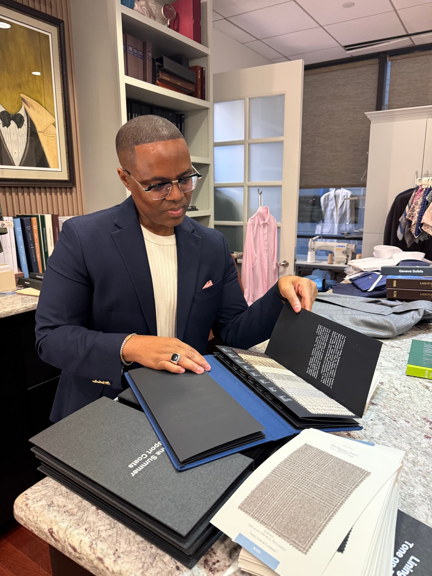 David McKnight looking down as he reviews fabric swatches in an open binder