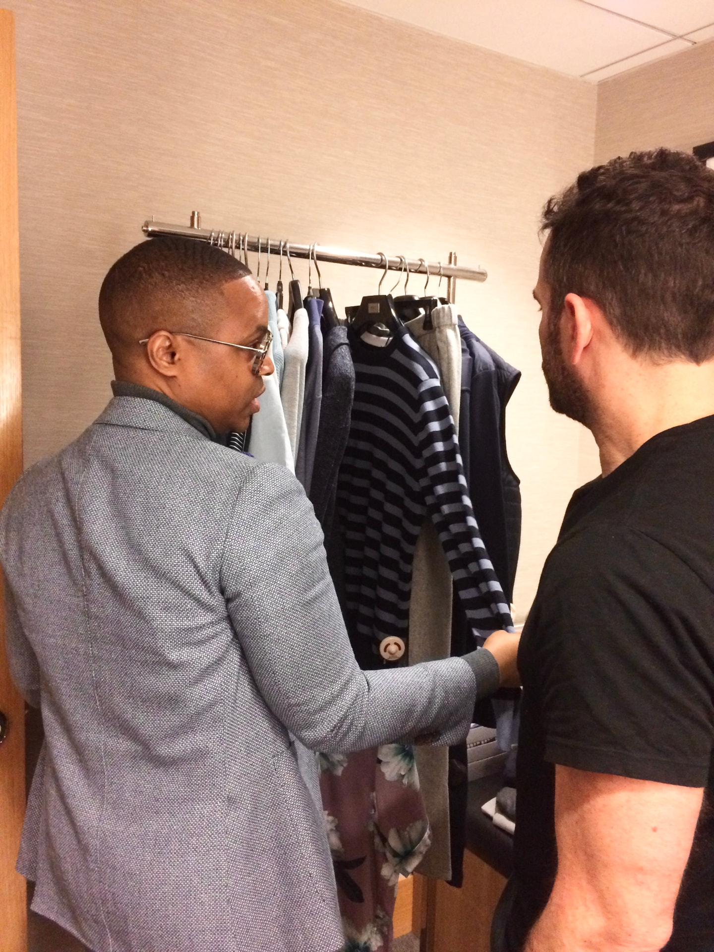 David McKnight reviewing garments with a client in a fitting room